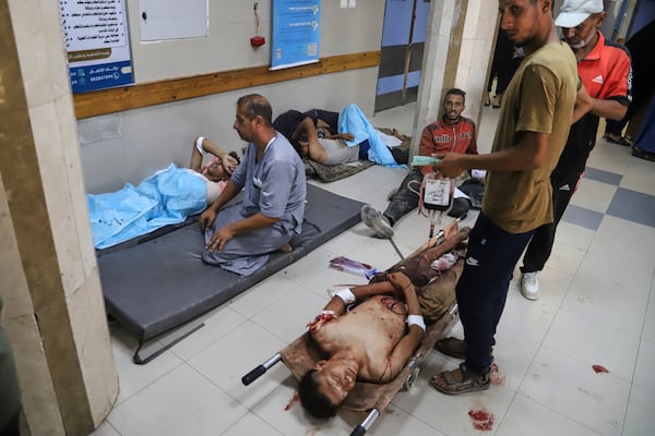 Palestinians who were injured during a food distribution at a center run by the Gaza Humanitarian Foundation, a U.S.-backed organization approved by Israel, receive treatment on the floor of Nasser Hospital in Khan Younis, southern Gaza Strip, Saturday, July 19, 2025. (AP Photo/Mariam Dagga)