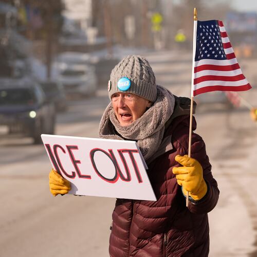 Rosie Grutze protests the presence of the U.S. Immigration and Customs Enforcement, Wednesday, Jan. 21, 2026, in Portland, Maine. (AP Photo/Robert F. Bukaty)