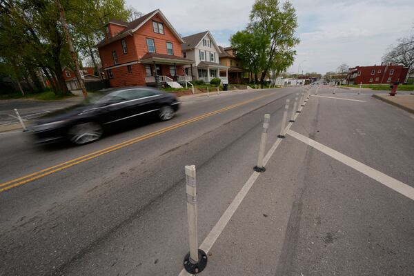A motorist drives on 31st Street in Kansas City, Mo., where the city implemented a "road diet" reducing the street from four lanes to two in an effort to reduce speeding and accidents, Thursday, April 17, 2025. (AP Photo/Charlie Riedel)