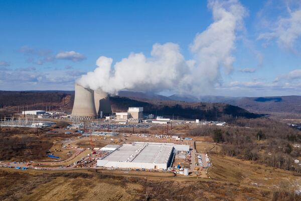 FILE - A data center owned by Amazon Web Services, front right, is under construction next to the Susquehanna nuclear power plant in Berwick, Pa., on Tuesday, Jan. 14, 2024. (AP Photo/Ted Shaffrey, File)