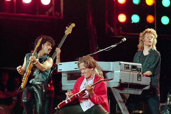 FILE - John Oates, from left, G.E.Smith and Daryl Hall perform at JFK Stadium in Philadelphia for the Live Aid famine relief concert on July 13, 1985. (AP Photo/Amy Sancetta, File)