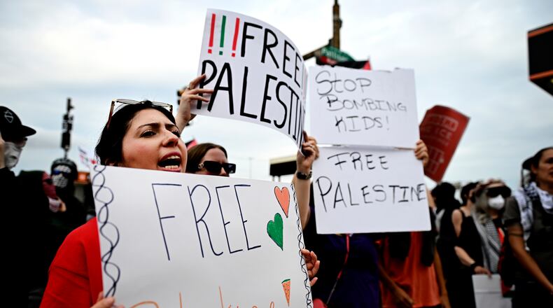 Pro-Palestinian demonstrators hold signs during a "Free Palestine" protest before an Ed Sheeran concert in Philadelphia, Saturday, Sept. 19, 2026. (AP Photo/Allie Ippolito)