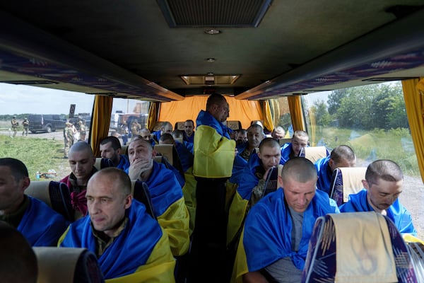 FILE - Ukrainian soldiers sit in a bus in the Sumy region of Ukraine after returning from captivity in Russia, May 31, 2024. (AP Photo/Evgeniy Maloletka, File)