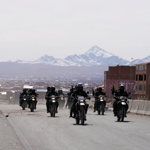 Police patrol a highway after President Rodrigo Paz declared a state of emergency to empower the military to remove road blockades, in El Alto, Bolivia, Saturday, June 20, 2026. (AP Photo/Juan Karita)
