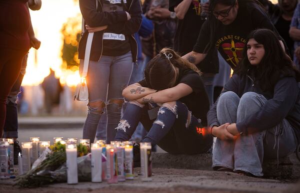 Family and friends mourn shooting victims during a vigil Young Park in Las Cruces, N.M., on Sunday, March 23, 2025. (Chancey Bush/The Albuquerque Journal via AP)