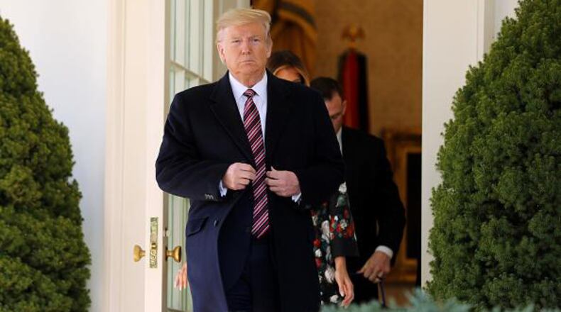 WASHINGTON, DC - NOVEMBER 25: U.S. President Donald Trump steps out of the Oval Office before posing for photographs with Conan, the U.S. military K9 that assisted in the raid that killed ISIS leader Abu Bakr al-Baghdadi, on the Rose Garden colonnade at the White House November 25, 2019 in Washington, DC. Trump talked about how the dog was a hero and said he presented the animal with a medal and a plaque. (Photo by Chip Somodevilla/Getty Images)