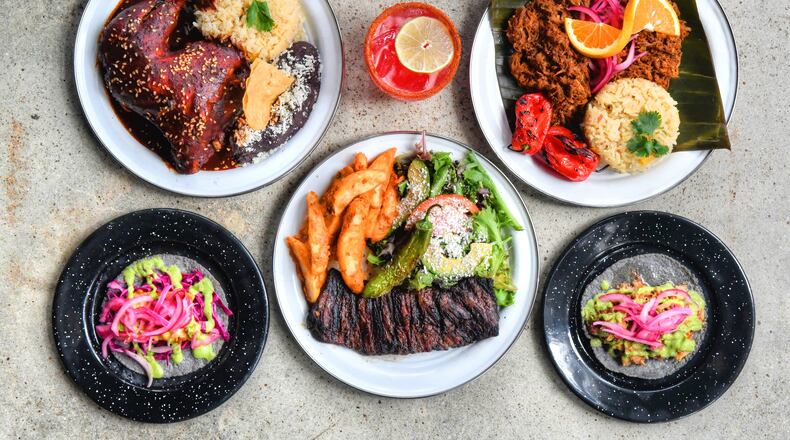 Offerings at Antiguo Lobo, a new Mexican restaurant in Chamblee, include (from top left) Pollo al Mole, El Melvin (cocktail) and Cochinita; (from bottom left) Pescado (taco), Carne Asada and Carnitas (taco). (Chris Hunt for The Atlanta Journal-Constitution)
