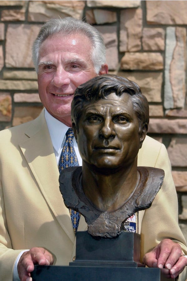 FILE - Former Miami Dolphins great Nick Buoniconti holds his bronze bust after enshrinement into the Pro Football Hall of Fame in Canton, Ohio, Aug. 4, 2001. (AP Photo/Mark Duncan)