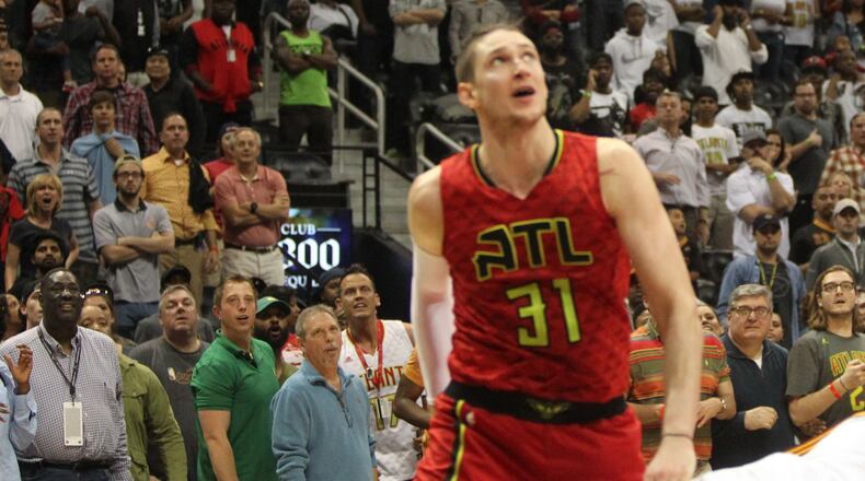 Fans react in the stands while Atlanta Hawks forward Mike Muscala (31) looks up in an NBA game between the Atlanta Hawks and Cleveland Cavaliers at Phillips Arena in Atlanta, Georgia, on April 9, 2017. The Hawks won in overtime 126-125 after coming back from being 26 points down in the fourth quarter. (HENRY TAYLOR / HENRY.TAYLOR@AJC.COM)