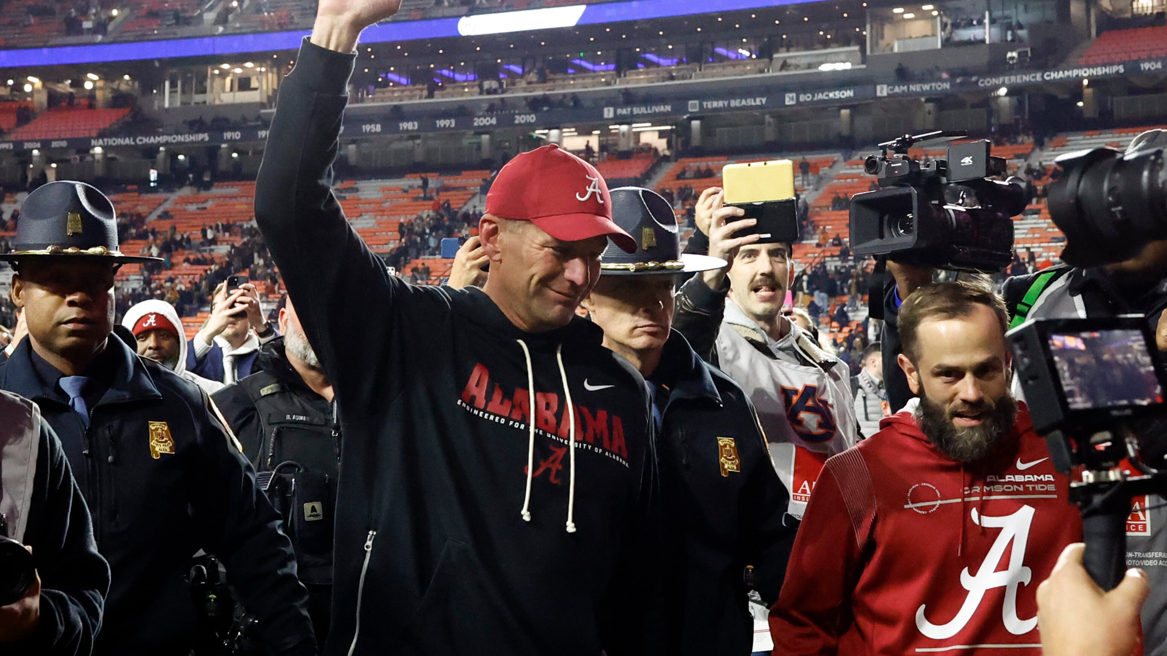 Alabama head coach Kalen Deboer, center, reacts after a win over Auburn in an NCAA college football game, Saturday, Nov. 29, 2025, in Auburn, Ala. (AP Photo/Butch Dill)