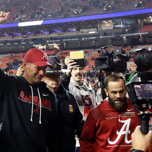 Alabama head coach Kalen Deboer, center, reacts after a win over Auburn in an NCAA college football game, Saturday, Nov. 29, 2025, in Auburn, Ala. (AP Photo/Butch Dill)