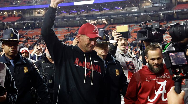 Alabama head coach Kalen Deboer, center, reacts after a win over Auburn in an NCAA college football game, Saturday, Nov. 29, 2025, in Auburn, Ala. (AP Photo/Butch Dill)