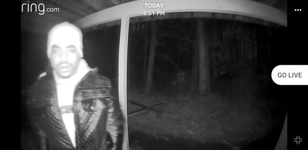 The woman’s security camera captured the man looking into her apartment.