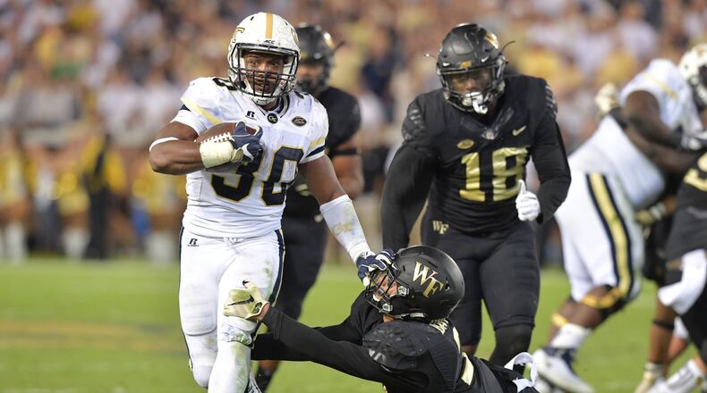 October 21, 2017 Atlanta - Georgia Tech running back KirVonte Benson (30) eludes a tackle by Wake Forest defensive back Jessie Bates III (3) in the first half of an NCAA college football game at Bobby Dodd Stadium on Saturday, October 21, 2017. HYOSUB SHIN / HSHIN@AJC.COM