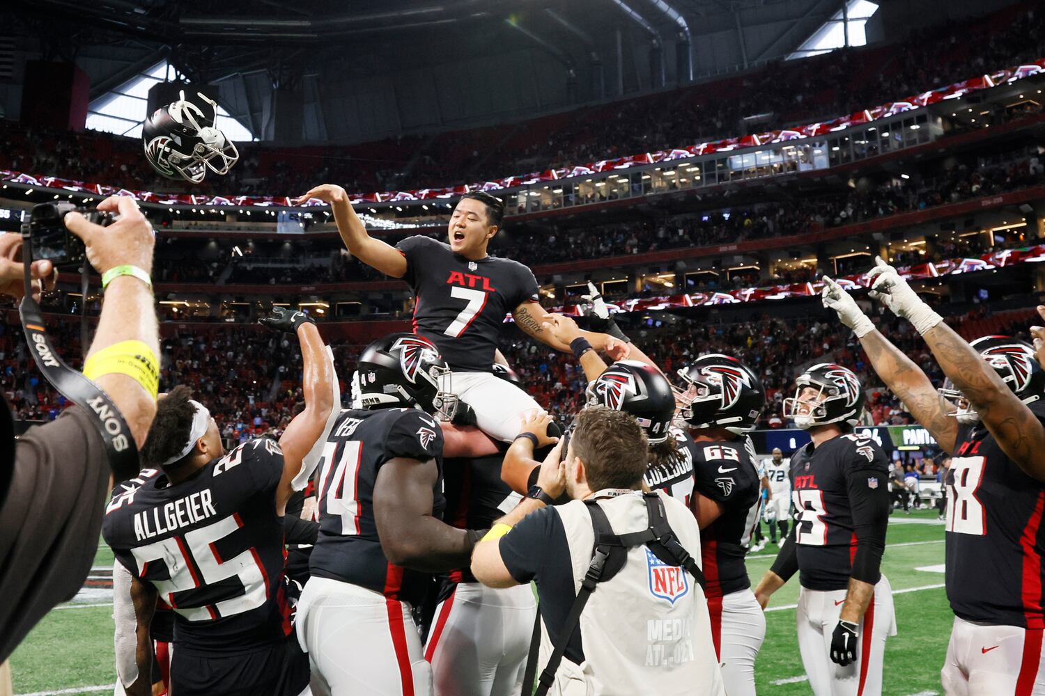 Falcons kicker Younghoe Koo tosses his helmet as he is being carried in teammates' shoulders after making the winning field goal overtime against the Carolina Panthers in Atlanta. The falcons defeated the Carolina Panthers 37-34.
Miguel Martinez / miguel.martinezjimenez@ajc.com