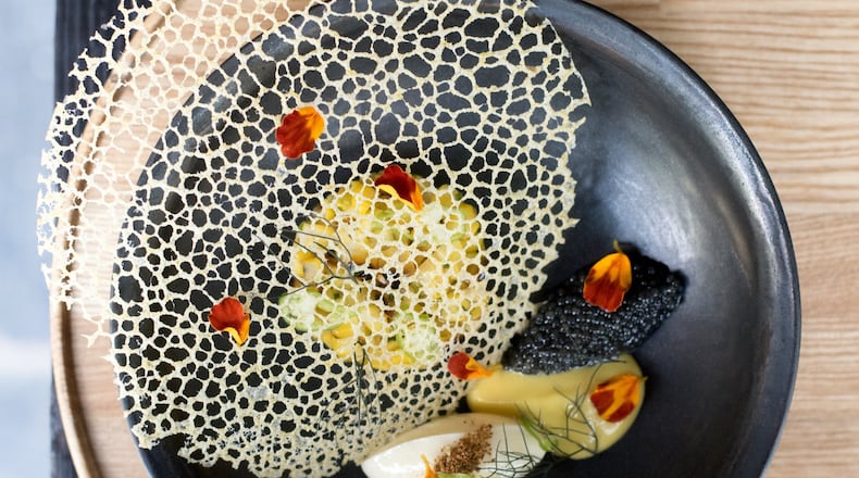 Why is Bacchanalia a first thought for fine dining in Atlanta? A first course of Sweet Local Corn includes a delicate lace tuile covering the corn pudding and spoonful of paddlefish caviar. CONTRIBUTED BY HENRI HOLLIS