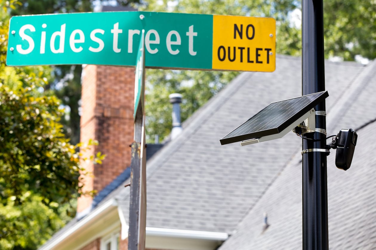 A Flock license plate reader, powered by a solar panel, is shown in the Sidestreet subdivision in Brookhaven in a 2020 file photo. The license plate reader takes a picture of each license plate that enters the neighborhood and keeps track of each vehicle’s comings and goings. (Casey Sykes for the AJC)