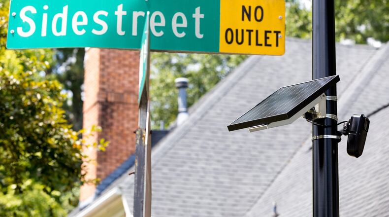 A Flock license plate reader, powered by a solar panel, is shown in the Sidestreet subdivision in Brookhaven in a 2020 file photo. The license plate reader takes a picture of each license plate that enters the neighborhood and keeps track of each vehicle’s comings and goings. (Casey Sykes for the AJC)
