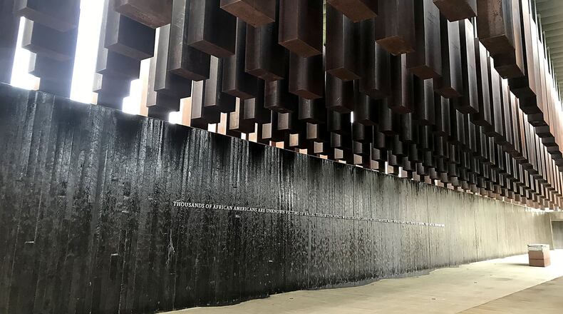 Stone markers hang high at the National Memorial for Peace and Justice in Montgomery, Ala. The markers recognize recorded lynchings that took place in Georgia and other Southern states. TIA MITCHELL / TIA.MITCHELL@AJC.COM