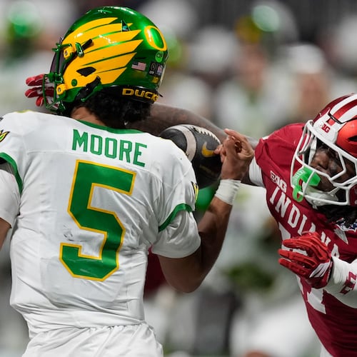 Indiana defensive lineman Daniel Ndukwe (17) pressures Oregon quarterback Dante Moore (5) during the first half of the Peach Bowl NCAA college football playoff semifinal, Friday, Jan. 9, 2026, in Atlanta. (AP Photo/Mike Stewart)
