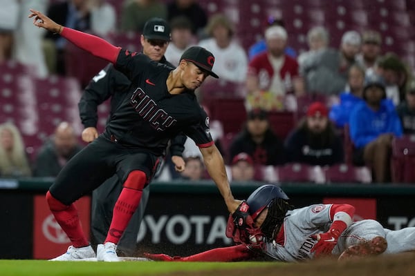 Washington Nationals' CJ Abrams, right, is tagged out as he is caught stealing by Cincinnati Reds third baseman Noelvi Marte, left, during the eighth inning of a baseball game, Friday, May 2, 2025, in Cincinnati. (AP Photo/Carolyn Kaster)