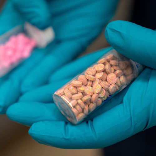 A forensic chemist with the Drug Enforcement Administration holds vials of fentanyl pills at a laboratory in northern Virginia. Almost everyone has a friend, classmate, family member or acquaintance who has overdosed from drugs that contained fentanyl, guest columnist Will Keyes writes. (Mark Schiefelbein/AP 2025)