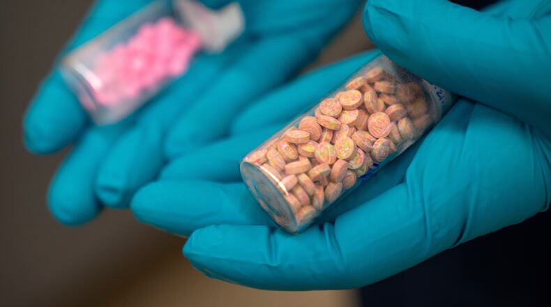 A forensic chemist with the Drug Enforcement Administration holds vials of fentanyl pills at a laboratory in northern Virginia. Almost everyone has a friend, classmate, family member or acquaintance who has overdosed from drugs that contained fentanyl, guest columnist Will Keyes writes. (Mark Schiefelbein/AP 2025)