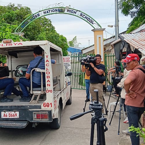 A police vehicle enters San Jose National High School a day after a shooting incident inside the school in Tacloban city, central Philippines, on Monday June 22, 2026. (AP Photo/Panfilo Vallejera)