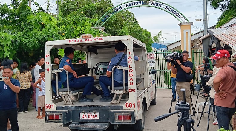 A police vehicle enters San Jose National High School a day after a shooting incident inside the school in Tacloban city, central Philippines, on Monday June 22, 2026. (AP Photo/Panfilo Vallejera)