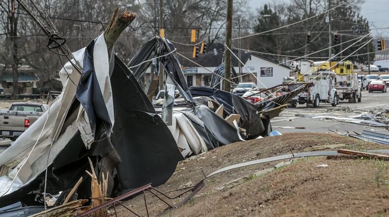 January 13, 2023 Spalding County: Traffic crawled along McIntosh Road in Griffin, Georgia on Friday, Jan. 13, 2023 following violent overnight storms. Gov. Brian Kemp said the powerful storms that swept through Georgia on Thursday killed at least two people and injured dozens, as he urged residents in damaged areas to stay clear of emergency crews working to repair power and remove debris. Authorities have traced at least four confirmed tornado tracks in Georgia. In Troup County, at least 50 homes were severely damaged, Stallings said. In Spalding County, another 130 people took refuge in an emergency shelter. Officials warned nearby residents that debris and fallen power lines are blocking crews from restoring power. Stallings urged them to stay where they are to avoid interfering with crews – and to be vigilant for falling debris that could cause more harm. (John Spink / John.Spink@ajc.com)