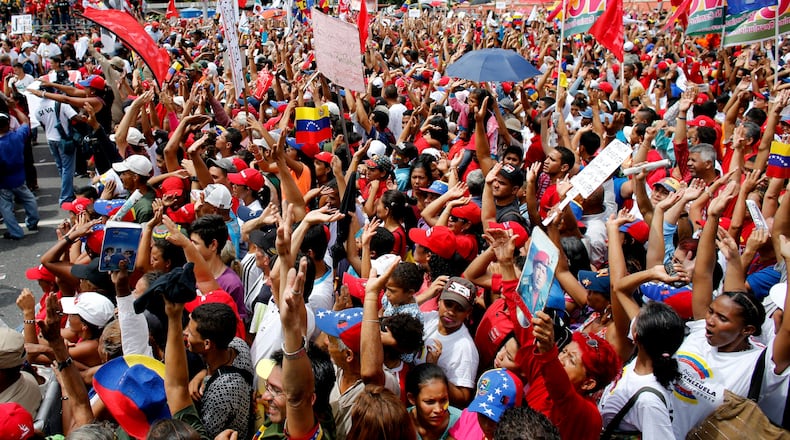 Supporters of Venezuela's President Nicolas Maduro cheer during a rally in Caracas, Venezuela, Thursday, July 27, 2017. Venezuela's President Nicolas Maduro has provoked international outcry and enraged an opposition demanding his resignation with his push to elect an assembly that will rewrite the troubled South American nation's constitution. Sunday's election will cap nearly four months of political upheaval that has left thousands detained and injured and at least 100 dead. (AP Photo/Ariana Cubillos)
