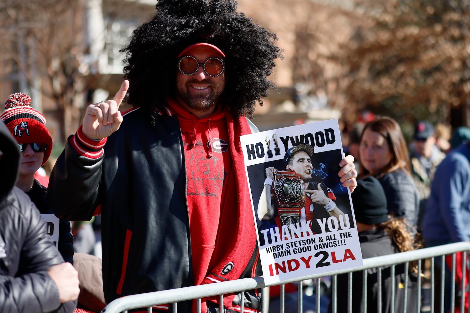 Ryan Jamieson from Buford shoe a sign as he awaits the team’s arrival at the Dawg Walk during the victory parade in Athens on Saturday, January 14, 2023. Miguel Martinez / miguel.martinezjimenez@ajc.com