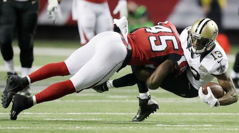 Atlanta Falcons middle linebacker Deion Jones (45) hits New Orleans Saints wide receiver Michael Thomas (13) during the first half of an NFL football game, Sunday, Jan. 1, 2017, in Atlanta. (AP Photo/David Goldman)