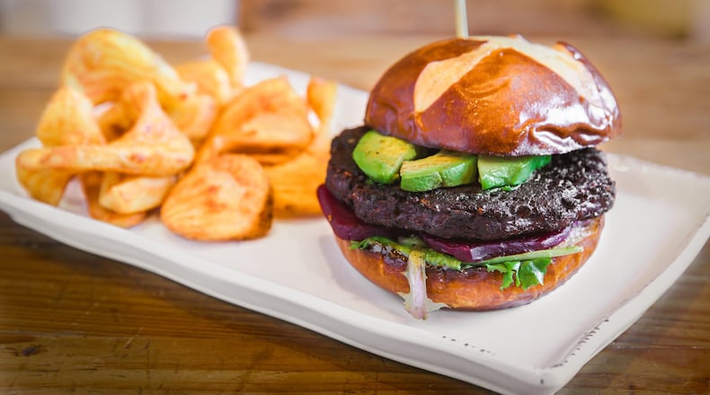 Nic & Norman’s offers a variety of gourmet burgers. The most recent version of the Norman’s Pick burger (pictured) is a vegetarian creation of a black bean patty dressed with soy ginger sauce, beets, avocado and spinach. Burgers come with an order of “sidewinder” fries or sweet potato fries. CONTRIBUTED BY DAVID MCCLONE / NIC & NORMAN’S