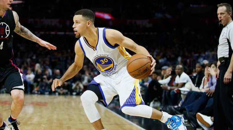 Golden State Warriors' Stephen Curry dribbles the ball against the Los Angeles Clippers during the second half of an NBA basketball game, Saturday, Feb. 20, 2016, in Los Angeles. The Warriors won 115-112. (AP Photo/Danny Moloshok)