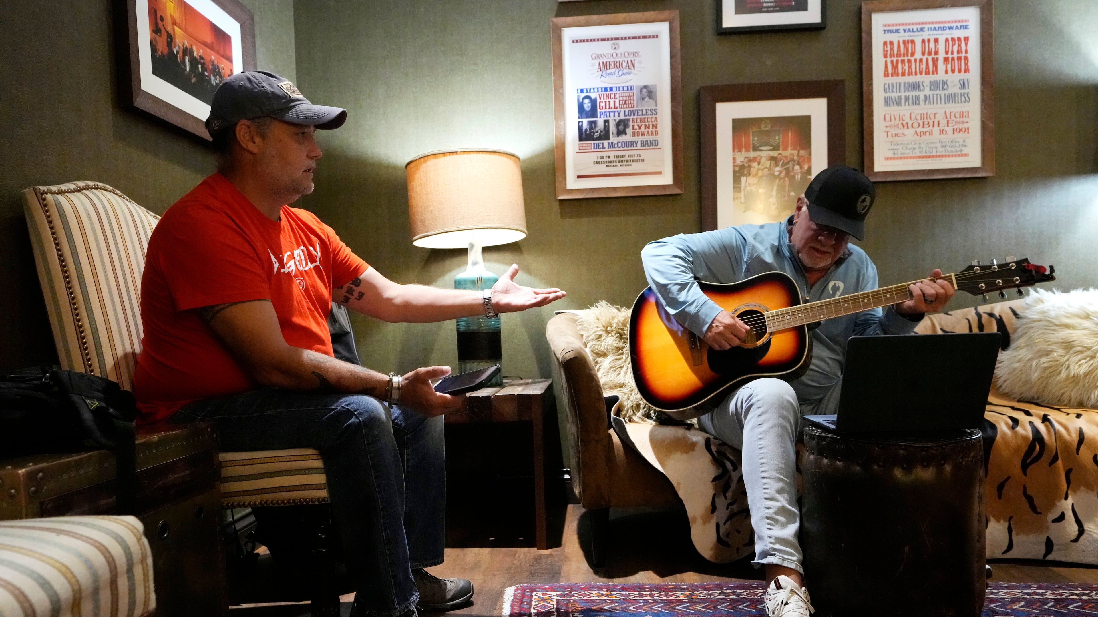 Army veteran Clay Jensen, left, talks about events in his military career as songwriter Brian White, right, puts them into lyrics as they work in a dressing room in the Grand Ole Opry House as part of the CreatiVets program on Tuesday, Sept. 8, 2025, in Nashville, Tenn. (AP Photo/Mark Humphrey)