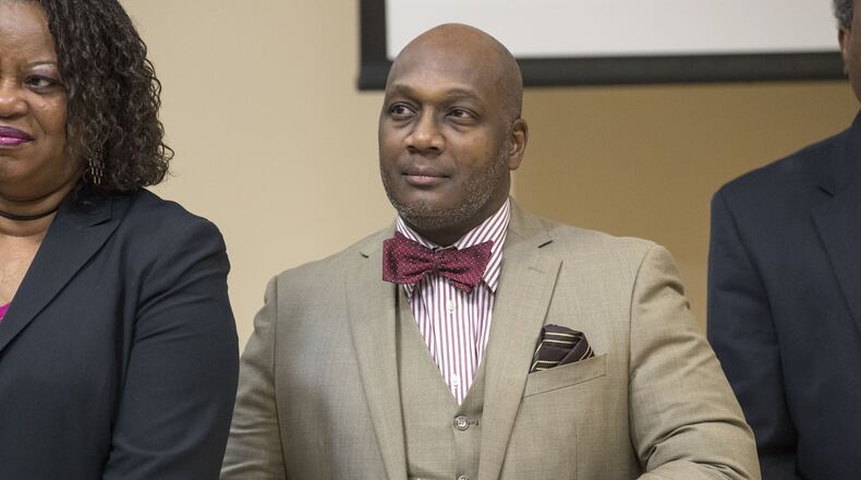 DeKalb Commissioner Gregory Adams stands with his colleagues during a presentation at a meeting in March. ALYSSA POINTER/ALYSSA.POINTER@AJC.COM