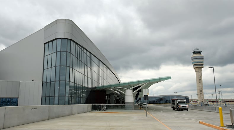 The International Terminal is shown with the main control tower in the background Monday morning in Atlanta, Ga., May 6, 2013. A year after Hartsfield-Jackson's $1.4 billion international terminal opened, there are still quirks that irk some travelers. The new terminal and Concourse F finally has its full array of restaurants, but it still is lacking some planned amenities. Among the changes that travelers are less enthused about are the lack of a MARTA stop and the long walk from arriving international flights on Concourse E to baggage claim. JASON GETZ / JGETZ@AJC.COM