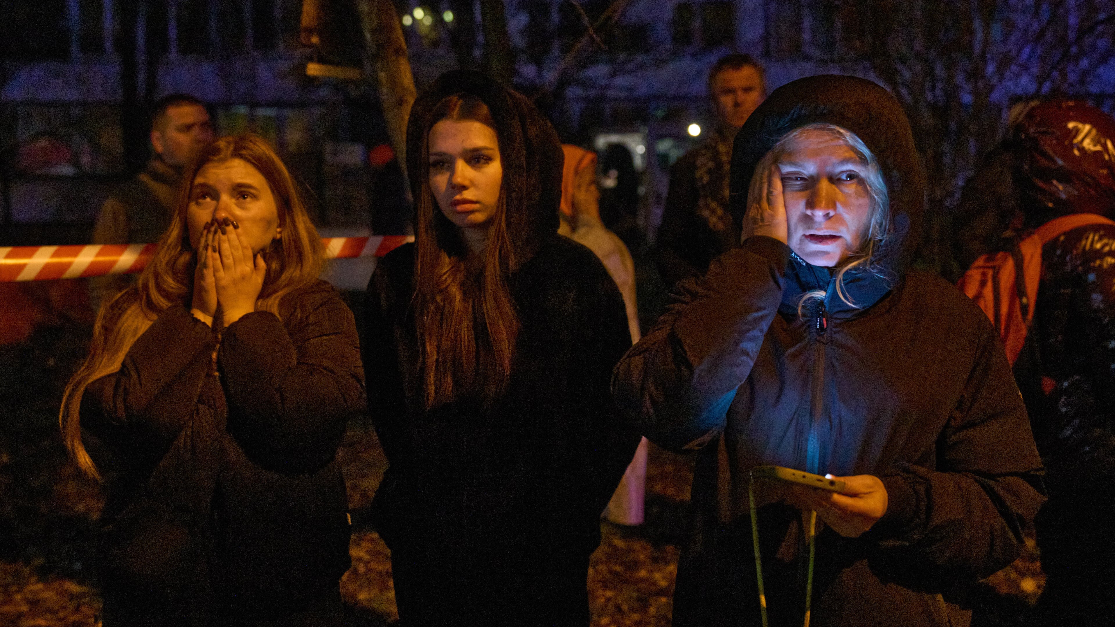 Local residents react as they watch their burning home after a drone hit a multi-storey residential building during Russia's night drone attack in Kyiv, Ukraine, Tuesday, Nov. 25, 2025. (AP Photo/Efrem Lukatsky)
