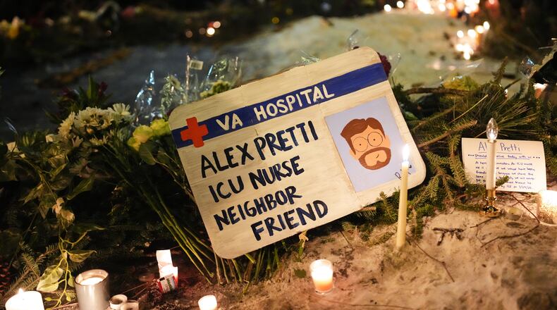 A sign for 37-year-old Alex Pretti, who was fatally shot by a U.S. Border Patrol officer Saturday, Jan. 24, 2026, is displayed during a vigil Saturday night in Minneapolis. (Adam Gray/AP)