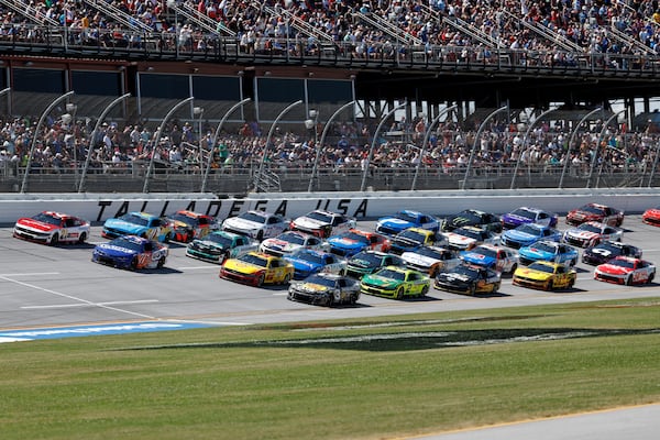 Drivers race four wide during a NASCAR Cup Series auto race at Talladega Superspeedway, Sunday, April 27, 2025, in Talladega, Ala. (AP Photo/Butch Dill)