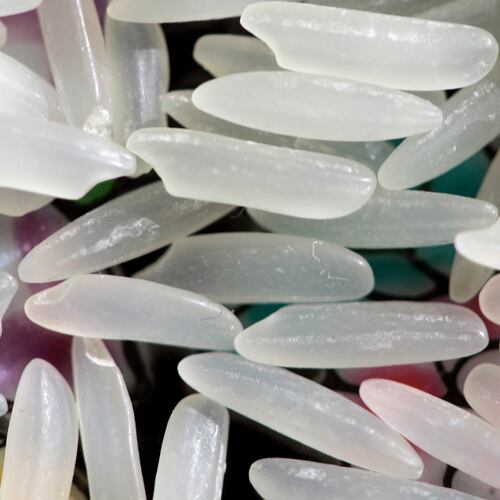 FILE - Grains of uncooked jasmine rice appear in Harrisburg, Pa., on April 24, 2008. (AP Photo/Carolyn Kaster, File)