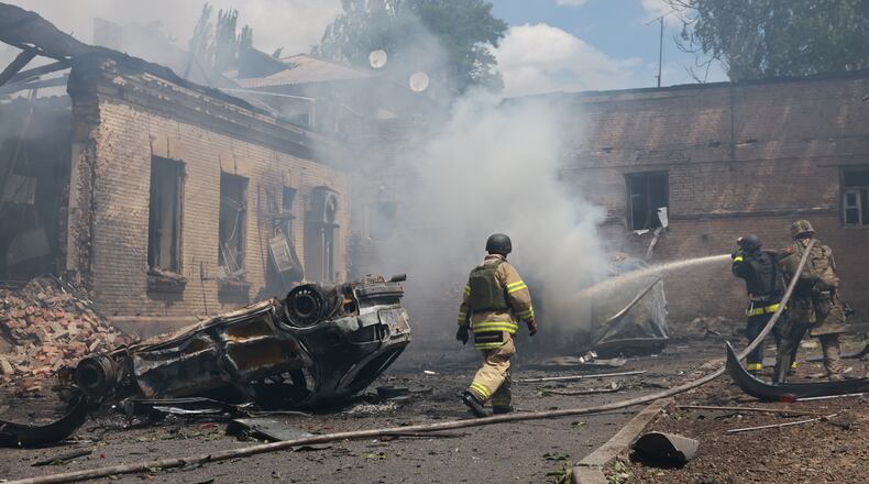 Rescue workers put out a fire at a building destroyed after a Russian strike on Zaporizhzhia, Ukraine, on Friday, June 26, 2026. (AP Photo/Evgeniy Maloletka)