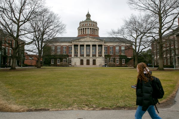 FILE - A student walks by the Rush Rhees Library at the University of Rochester on Wednesday, February 22, 2023. (AP Photo/Ted Shaffrey, File)