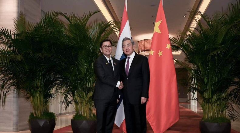 In this photo released by the Thai Ministry of Foreign Affairs, Thai Foreign Minister Sihasak Phuangketkeow, left, shakes hands with Wang Yi, Chinese Foreign Minister, in Yunnan Province, China, Sunday, Dec. 28, 2025. (Thai MFA via AP)