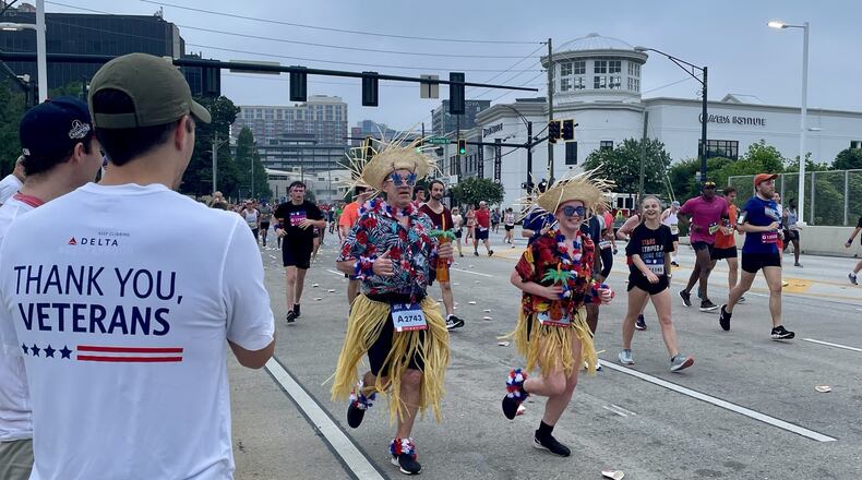 Delta Air Lines employees cheer on runners at the AJC Peachtree Road Race in 2022, part of the airline's decades-long involvement in the race. Courtesy of Delta