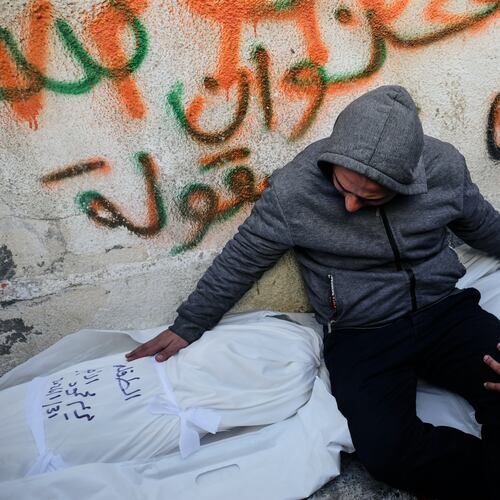 Mahmoud Al-Atbash mourns the bodies of his two daughters, Zeina and Maryam, who were killed in an Israeli military strike, at Shifa Hospital in Gaza City Saturday, Jan. 31, 2026. (AP Photo/Jehad Alshrafi)