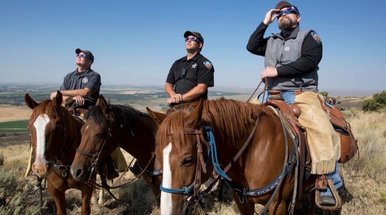 The Madison County Sheriff's Mounted Patrol  in Idaho watched the eclipse atop horses .