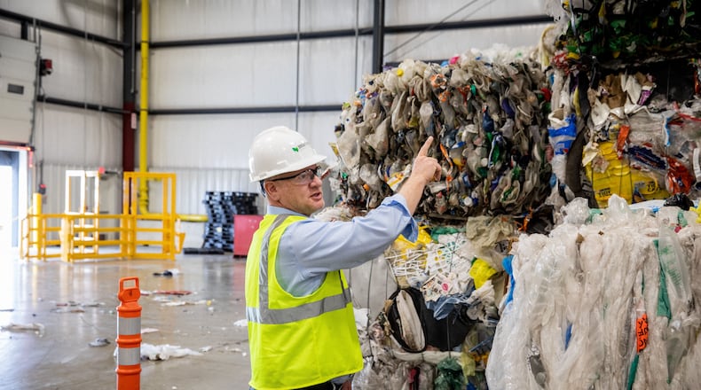 Bob Powell, a Georgia Tech graduate and CEO and founder of Brightmark stands among bales of plastic wastes at a processing plant in Indiana. The company plans to build a massive plastic waste processing plant in Georgia that will turn plastic into diesel fuel, naptha and wax. Powell wants one day to turn the plastic into new plastic, helping solve the massive problem of plastic pollution. But that process isn't economically viable at the moment. Photo courtesy of Brightmark.