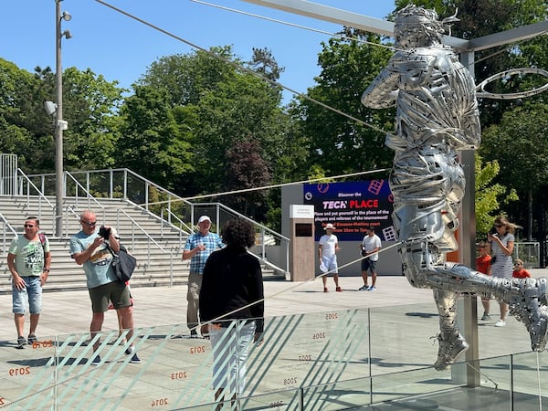 FILE - Tennis fans take images of Spain's Rafael Nadal's statue during their first round match of the French Open tennis tournament at the Roland Garros stadium in Paris, May 29, 2023. (AP Photo/Howard Fendrich, File)